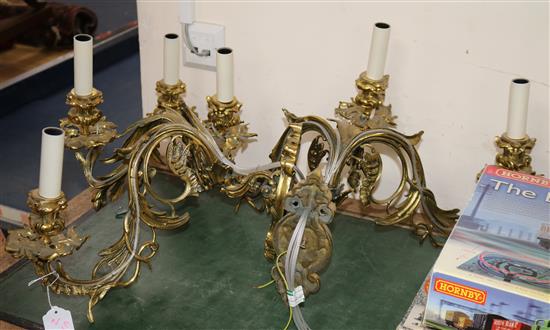 A pair of ormolu three light wall appliques, height 10in. depth 15in.